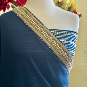 Tara Prussian blue georgette saree with a gold sequin embroidered border and a matching heavy work blouse piece.